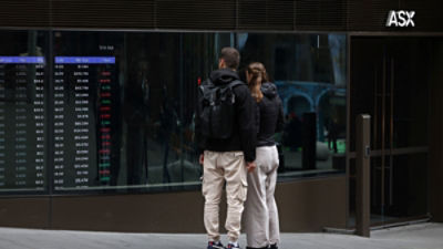 People look at stock prices displayed on a market board at the Australian Securities Exchange (ASX) in Sydney, Australia, September 11, 2026. REUTERS/Hollie Adams