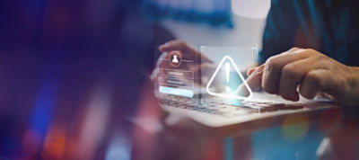 Image of someone using a keyboard with warning signs.