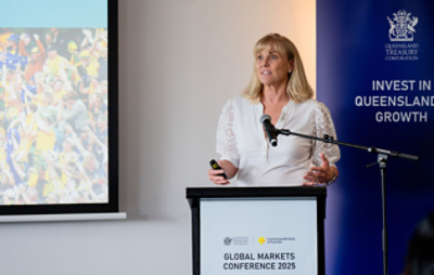 Photo of Cindy Hook in a small room presenting for the global markets conference 2025