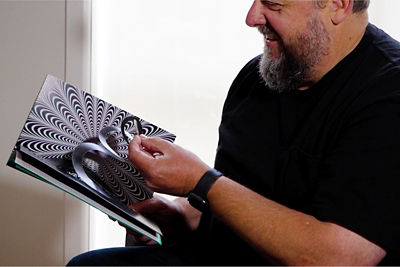man observing printed items