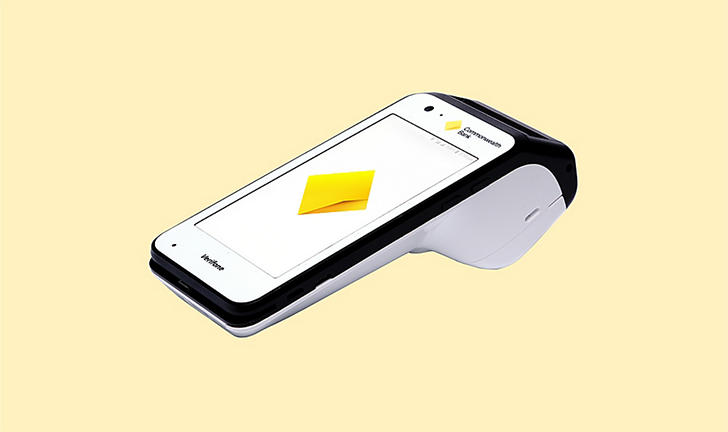 The Smart terminal is a sleek machine, with a touchscreen and a border with the CommBank logo.