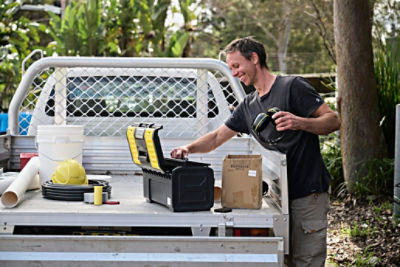 Tradie opening toolbox on ute