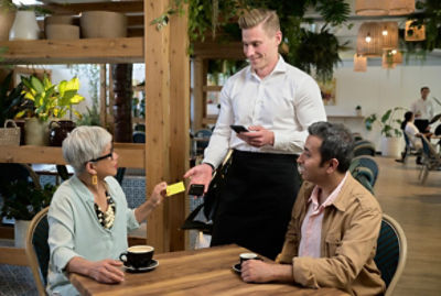 Woman paying for coffee with card 