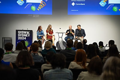 Panellists sitting on stage in front of audience at SXSW Sydney 2024.