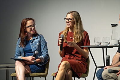 Two people holding microphones while sitting on stage at SXSW Sydney 2024.