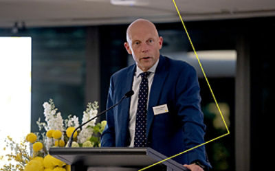 CommBank’s Andrew Hinchcliff speaking at a lectern at CommBank SXSW Brighter Futures Dinner.