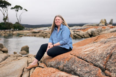 St Helen’s Neighbourhood House’s Tanya Greenwood sitting on rocks.    