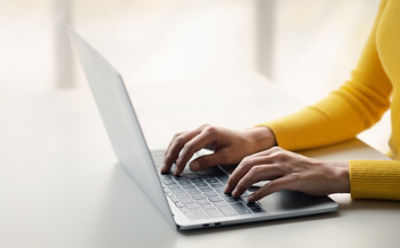 Woman at a table with a laptop