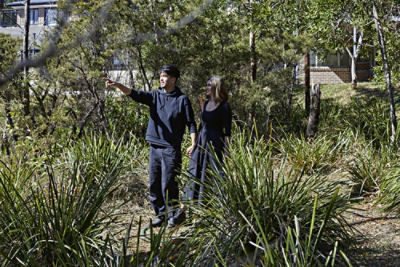 Quincy Lim and Krish Waje standing in the backyard of their Blue Mountains property.